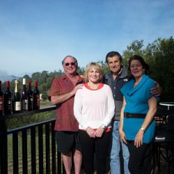 Ramazzotti guests with wine bottles on estate balcony