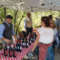 Summer party guests at pouring table